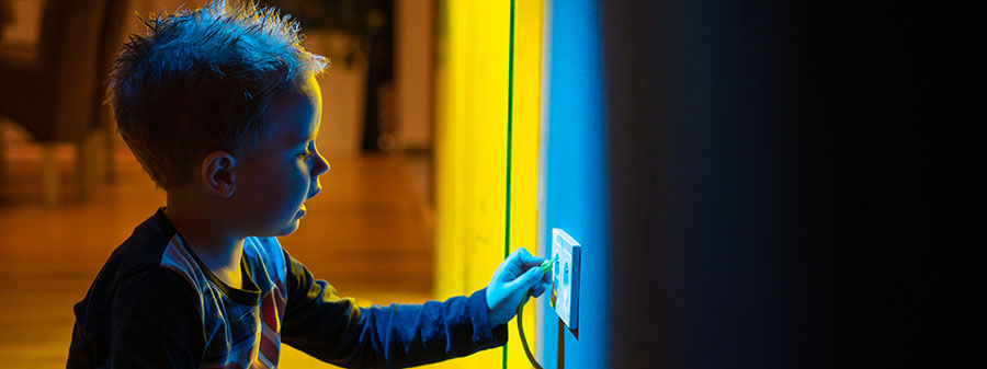 Small kid playing with an electric socket