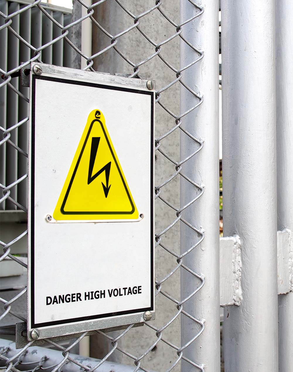 Electrical hazard sign placed on a metal fence