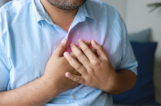 Man clutching chest with discomfort.