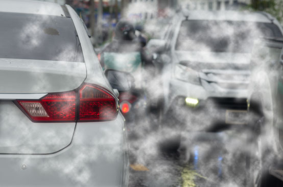 Cars emitting smoke in traffic jam