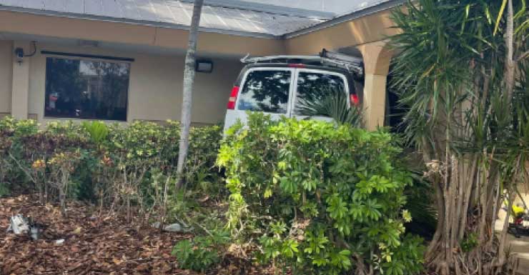 1 critically hurt after van crashes into building, fire officials say
