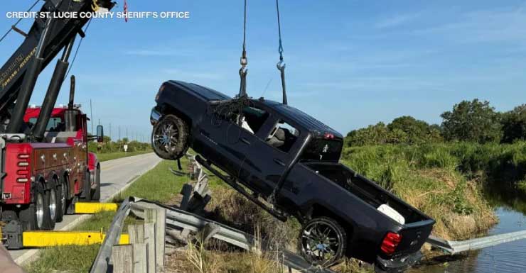 PHOTOS: Dive team pulls empty truck out of canal after it smashed through guardrails