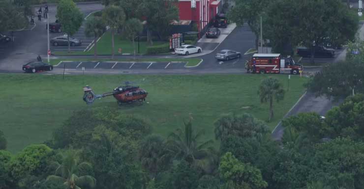 North Lauderdale fire rescue personnel help driver out of overturned car in canal