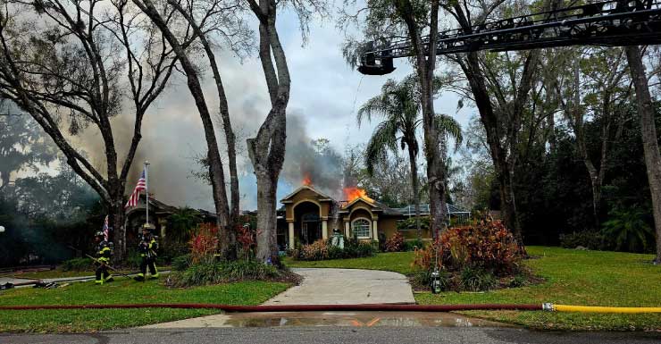Firefighter hospitalized while battling large house fire in Lutz