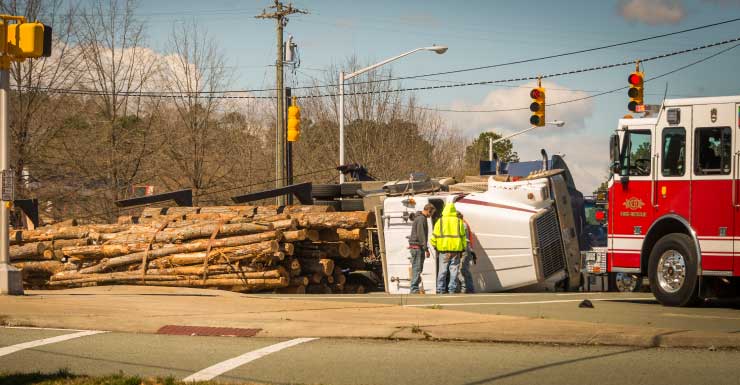 Dump truck rollover blocks lane on Alico Road in Lee County