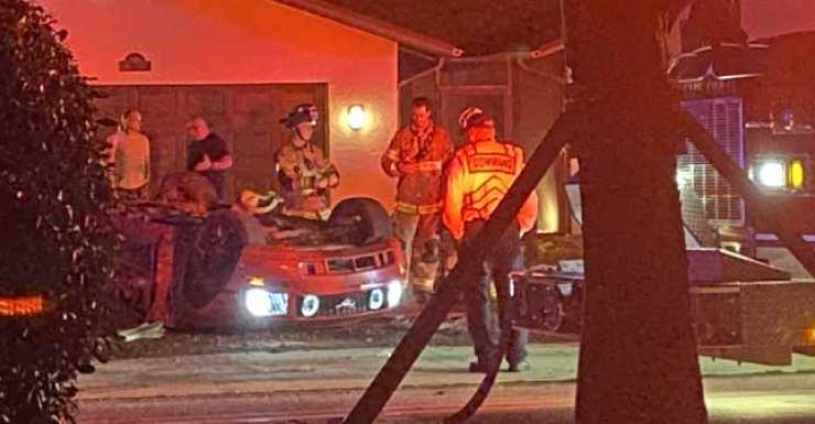 Rollover crash in Cape Coral leaves car upside down in front of a home
