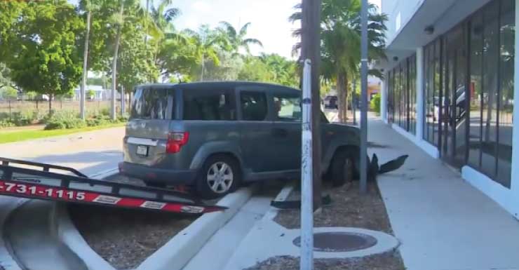 2-vehicle crash leaves car on its side, another against Fort Lauderdale building