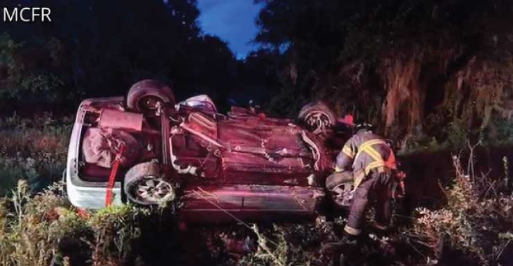 Pickup truck wedged between tree and fence sends two to hospital