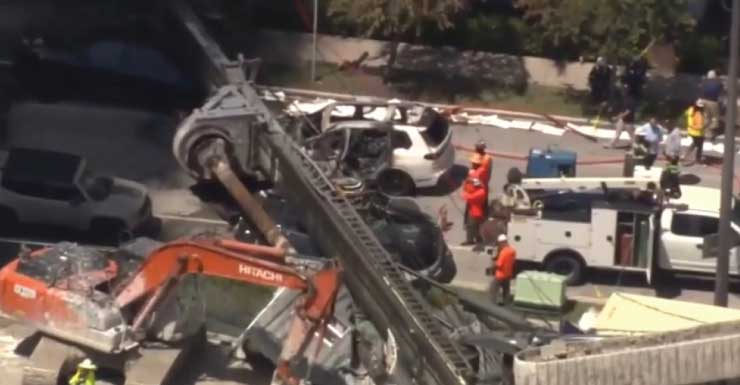3 construction workers, driver hospitalized after drilling rig collapses onto Brickell Bay Drive, sparking SUV fire